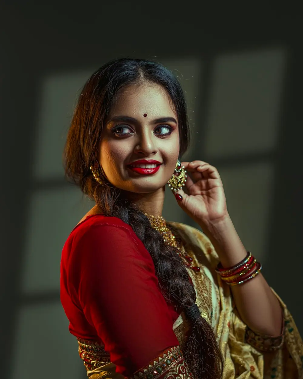 Woman in a red blouse and golden silk saree